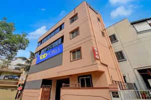 a building with a blue sign on the side of it at FabHotel Dream Sky in Kharadi
