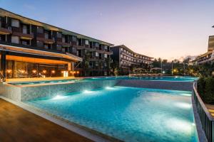 a large swimming pool in front of a building at Wing Samui Condo 102 in Nathon Bay