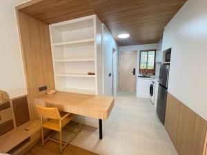 a small dining room with a table and a kitchen at Wing Samui Condo 102 in Nathon Bay