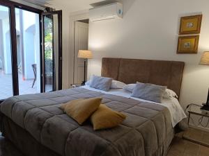 a bedroom with a large bed with two pillows on it at B & B Villa Flora in Mondello
