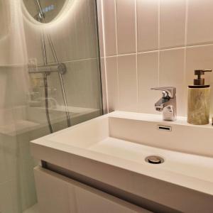 a white bathroom with a sink and a shower at Chalet Le Reposou in Laguiole +49 photos