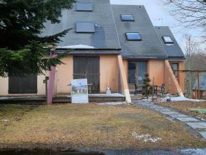a house with a sign in front of it at Chalet Le Reposou in Laguiole