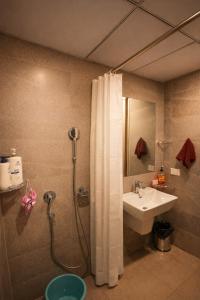 a bathroom with a shower and a sink at Midnight Atelier in Greater Noida +20 photos
