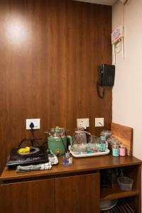 a kitchen counter with a table with food on it at Midnight Atelier in Greater Noida