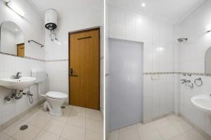 a bathroom with a toilet sink and a shower at FabHotel Vardhmaan Inn in New Delhi +23 photos