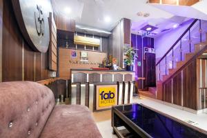 a living room with a couch and a glass table at FabHotel Vardhmaan Inn in New Delhi