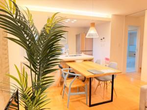 a dining room with a table and a potted plant at Franmare in Okayama
