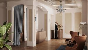 a man in a suit standing in a hallway at Taj Hessischer Hof Frankfurt in Frankfurt