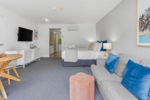 a living room with a couch and a bed at Bay View Style in Lorne