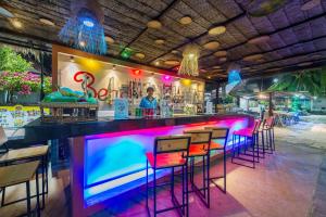 a bar with pink and blue lighting in a restaurant at Blue Bay Resort - Access to Pool and Beach-Phuket & Krabi in Ko Yao Yai