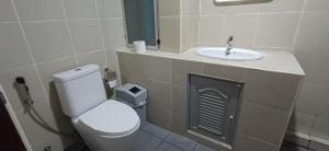a bathroom with a toilet and a sink at P & T Guesthouse in Bangrak Beach +60 photos