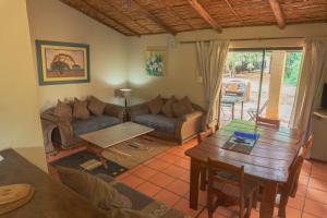 a living room with a couch and a table at Gallery Inn in Bela-Bela