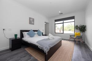 a bedroom with a large bed and a window at Winchester Residence in Armadale