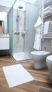 a bathroom with a shower and a toilet and a sink at Central in Casarile +38 photos