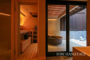 a bathroom with a tub and a glass door at IORI Stay in Takayama +35 photos
