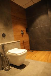 a bathroom with a white toilet in a room at Hotel Barai Palace in Dwarka +11 photos