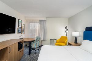 a hotel room with a bed and a desk at Hampton Inn Marietta in Marietta