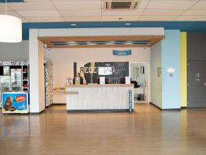 a lobby of a store with a counter and a pharmacy at ibis budget Manhuaçu in Manhuaçu