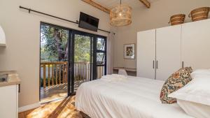 a bedroom with a bed and a large window at The Wellington Residence in George