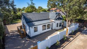 an overhead view of a white house with a fence at The Wellington Residence in George