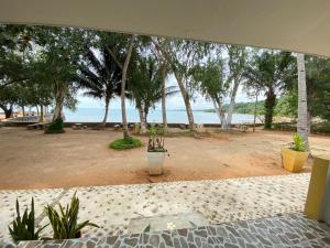 a view of the beach from the porch of a house at Issara Beach Resort in Sichon