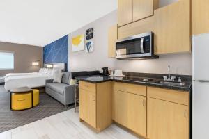 a kitchen and living room in a hotel room at Comfort Inn Ballard-Roosevelt in Roosevelt