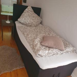 a bed with two pillows on top of it at Ferienhaus Meiers in Losheim