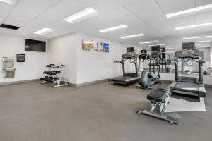 a gym with several tread machines in a room at Comfort Inn & Suites Houma in Houma
