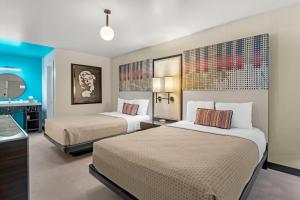 a hotel room with two beds and a bathroom at Heights House Hotel - Houston Heights Downtown, an Ascend Collection Hotel in Houston +126 photos