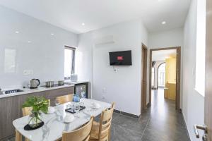 a kitchen and dining room with a table and chairs at Tidal Mist Homestay in Long Hai