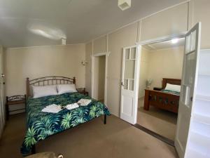 a bedroom with a bed with towels on it at Wild Platypus Stays in Eungella