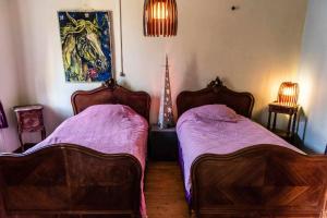 a bedroom with two beds and a christmas tree at petite maison artistique in Saint-Plantaire