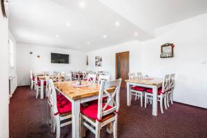 a dining room with wooden tables and chairs at Penzion Neubauer in Ostružná