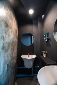 a bathroom with a sink and a mirror at Bud Brew Beyond Dispensary and Hotel in Bangkok +241 photos