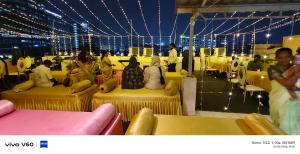 a group of people sitting on tables in a room at Hotel I Live Inn in Chennai