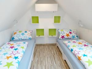 two beds in a small room with colorful at Ferienwohnung Seenlandwinkel in Wackersdorf +47 photos