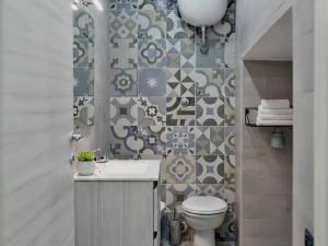 a bathroom with a sink and a toilet and a wall at Capodimonte Home in Naples +48 photos