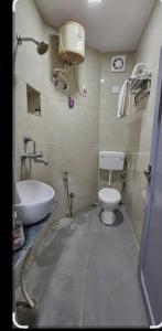 a bathroom with a sink and a toilet and a tub at Hidden paradise homestay in Rongli