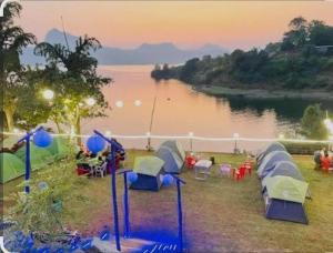 a group of tents sitting next to a lake at Hidden paradise homestay in Rongli