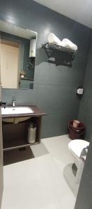 a bathroom with a sink and a toilet and a mirror at Aair Hotel And Resorts in Karnal +9 photos