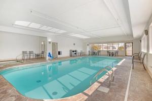 a large swimming pool with blue water in a building at Comfort Inn Sullivan in Sullivan