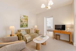 a living room with a couch and a table at Maison del Mar in Hobart