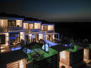 a night view of a building with blue lights at Bela Villas in Kallithea Halkidikis