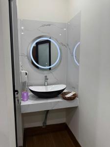 a bathroom with a sink and a mirror at XƠ ĐĂNG homestay in Kon Plong