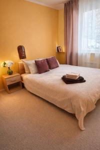 a bedroom with a large bed and a window at Puhkepesa 6 in Otepää +10 photos