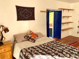 a bedroom with a bed with a pillow on it at Authentic Peruvian home with gorgeous patio in Pisac