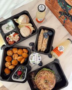 a table with four trays of food on it at Apartamenty 3 Owce z widokiem na Giewont in Kościelisko