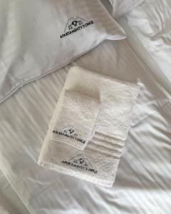a white blanket with two towels on a bed at Apartamenty 3 Owce z widokiem na Giewont in Kościelisko