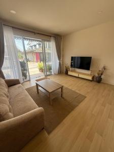 a living room with a couch and a flat screen tv at Summer Sand in Haad Rin
