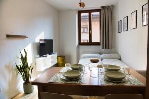 a living room with a table with dishes on it at Appartamenti Ventuno in Riva del Garda